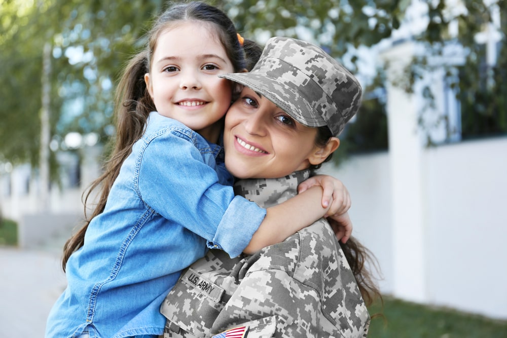 veteran holding her daughter